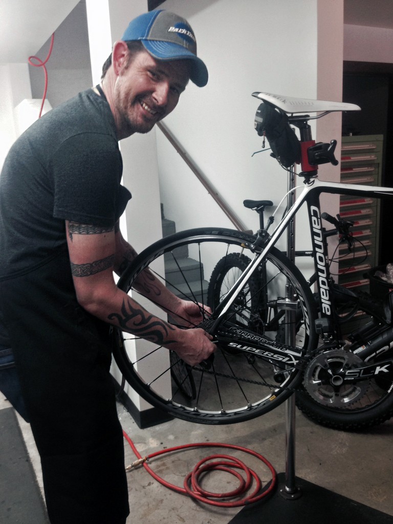 Charles Keithley works on a bike at Cherry Creek Cyclery. Photos by George Demopoulos.