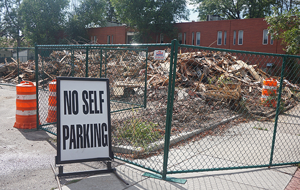 A pet store building and a surface parking lot are in the process of demolition. Photo by Burl Rolett.