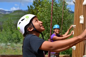 An ELK student learns the ropes of climbing at a 2014 event.