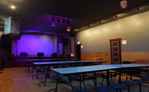 The space includes outdoor seating, a bar and a stage. 