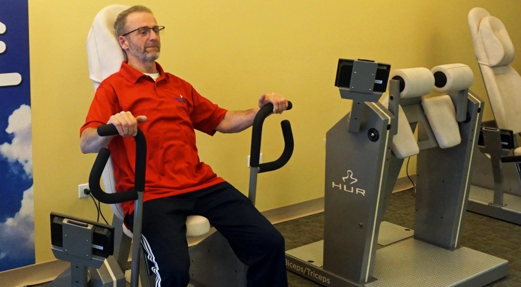 Welcyon employee Norm Cook demonstrates the use of a Hur exercise machine. Photos by George Demopoulos.
