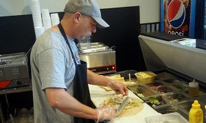 Kevin Singer makes a Dixie Chicken (chicken salad) sub sandwich. Photo by George Demopoulos.