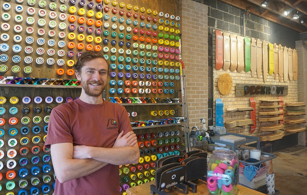 Daniel Peterson, retail manager at BoardLife, stands in front of the store's "Deck It Out" section. (Kate Tracy)